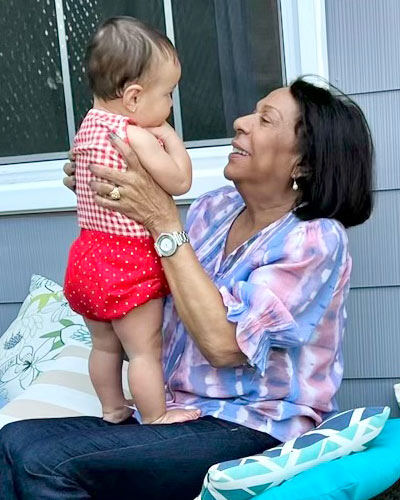 JD Suarez's grandmother holds his infant daughter