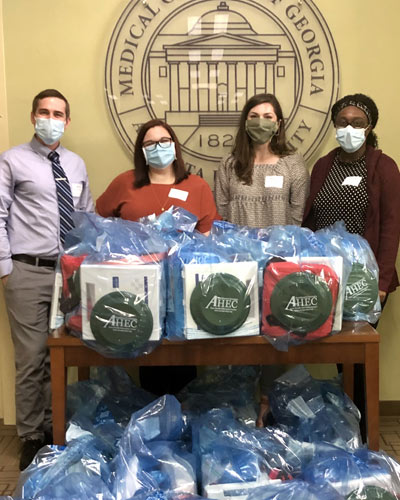 PCOM South Georgia medical students pose with AHEC swag bags