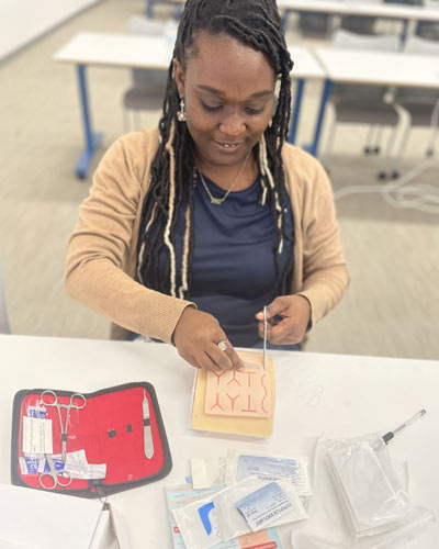 An incoming PCOM med student learns suturing techniques