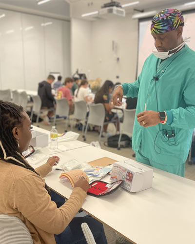 An incoming PCOM med student learns suturing techniques