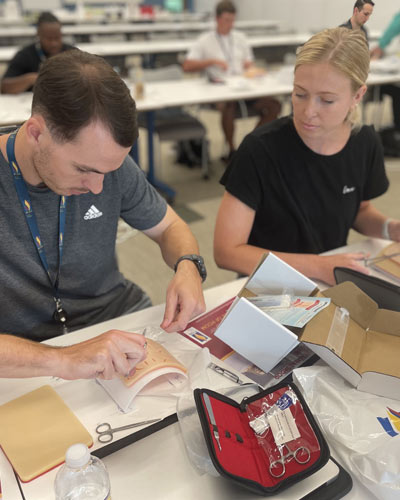 Incoming PCOM DO students practice suturing techniques