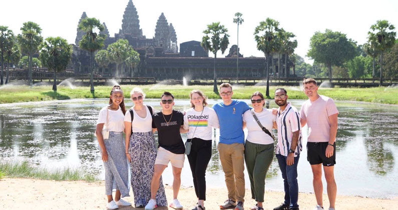 PCOM South Georgia students in Cambodia posing for a group photo with the Angkor Watt temple in the background 