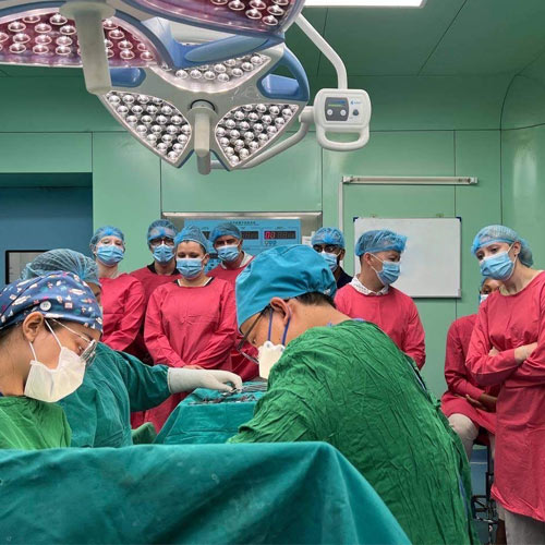 DO students observe a C-section delivery in an operating room in Cambodia