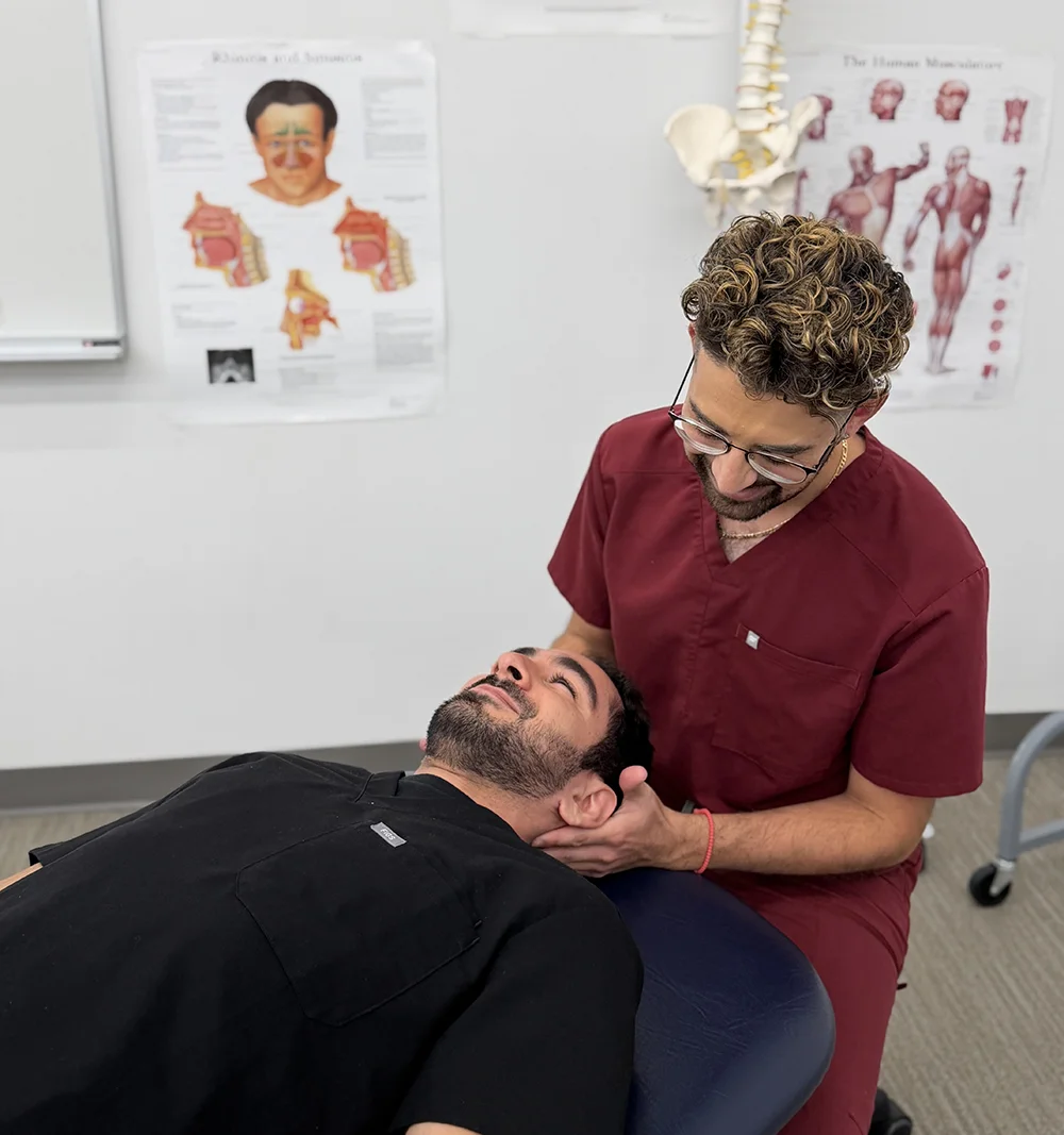 A clinical scholar student practices an OMM technique on a fellow student in a lab at PCOM South Georgia