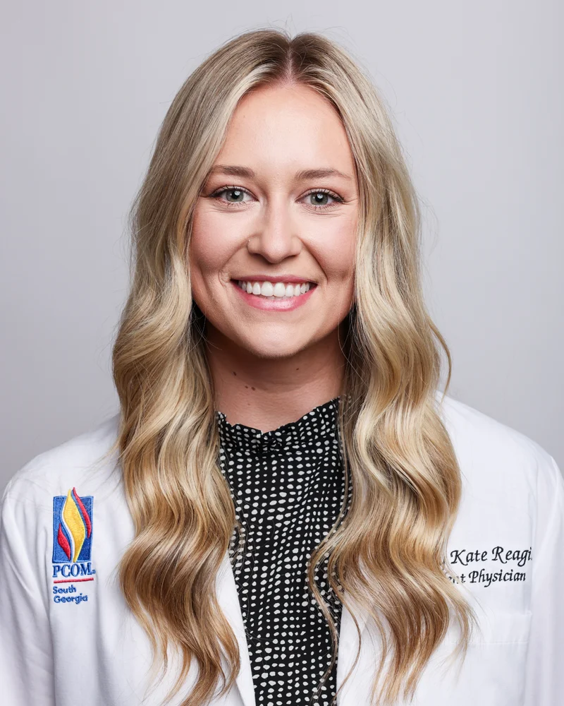 Professional headshot of Emily Regin (DO '27) wearing white coat