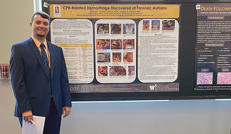 Osteopathic medical student Samuel P. Prahlow (DO ‘24) stands next to his research poster presentation