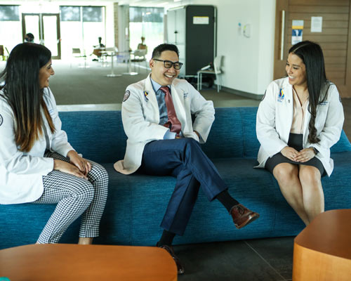 Medical students sit on lobby couch