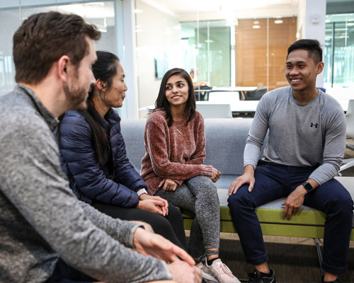 College students conversing on a sofa