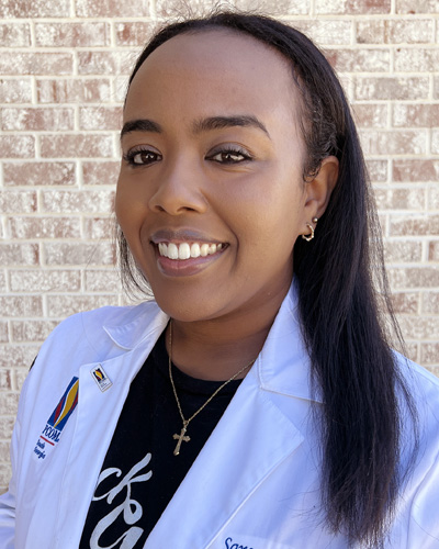 Headshot photo of PCOM South Georgia med student Saron Araya (DO '27) wearing her student physician white coat