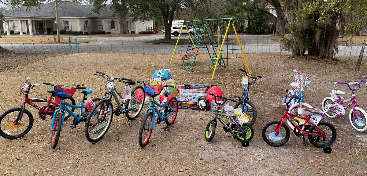 A row of donated children's bicycles, toys and sports and playground equipment raised through PCOM South Georgia's toy and bike drive