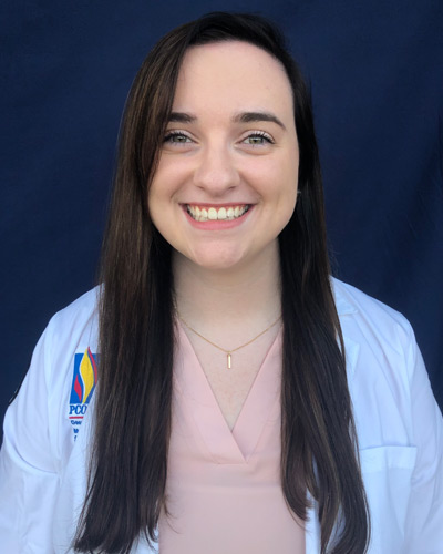 Headshot photograph of first year med student Macy Rowan (DO '24) wearing her physician white coat