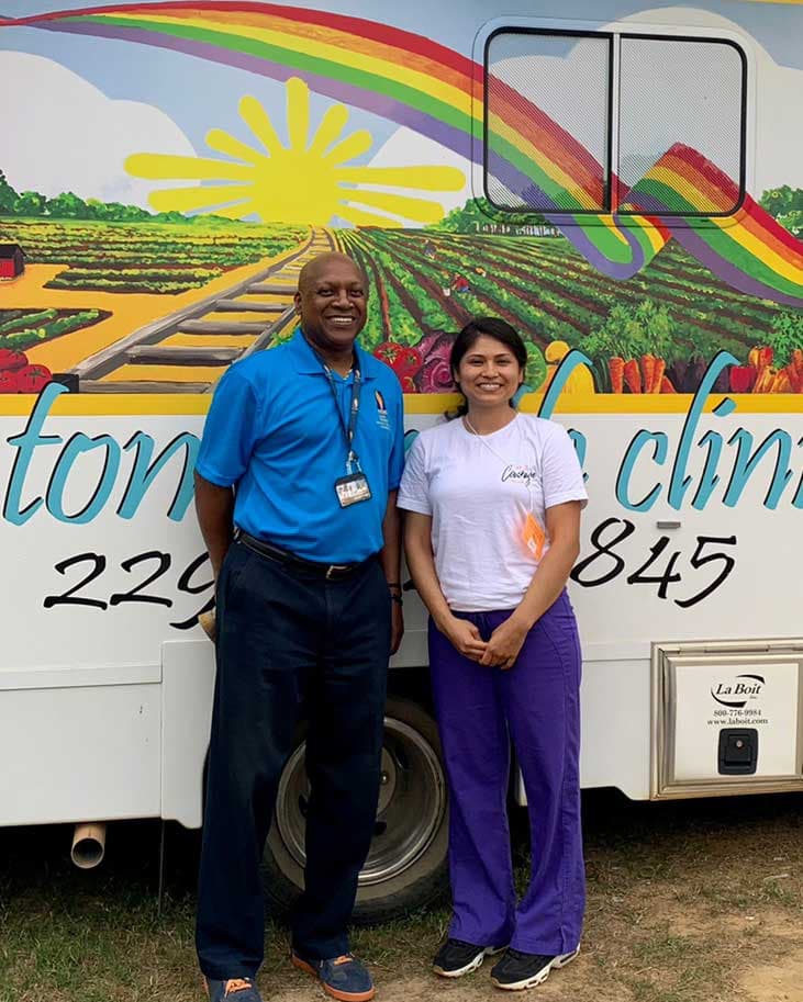 Winston Price, MD, poses with another volunteer at the migrant healthcare site.