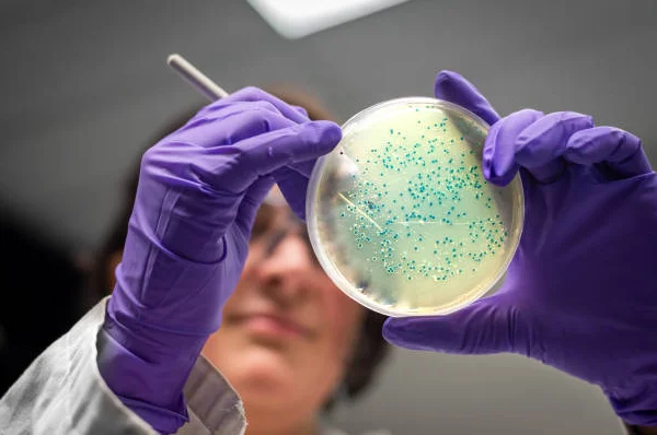 Lab tech gathers sample for testing