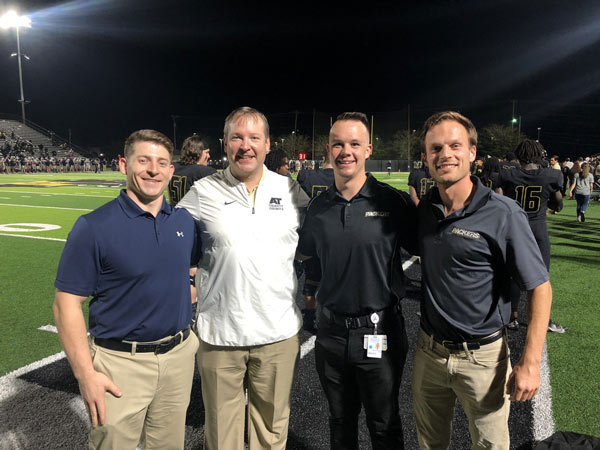 Trent Griner and members of medical staff on sidelines of football game