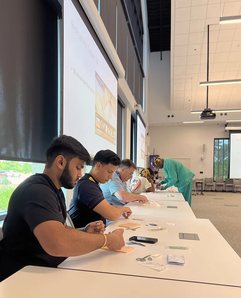 First-year medical students work with faculty during a hands-on learning exercise during PCOM South Georgia's FIRE program for new incoming students