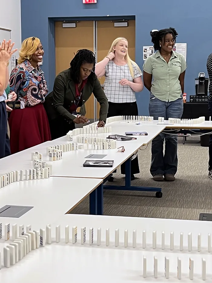New medical students at PCOM South Georgia work together with dominos during a team building exercise during the med school introductory summer program