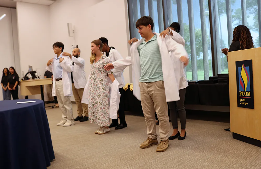 Colquitt area teens don student physician white coats during a summer STEM and medical careers summer program at PCOM South Georgia in Moultrie
