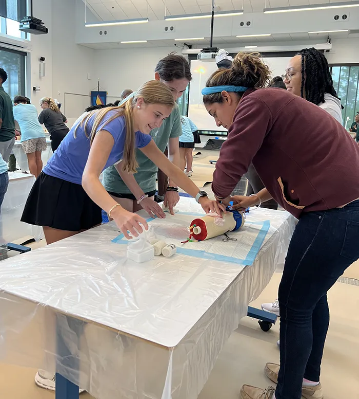 High school students work with medical students on surgery simulation equipment during PCOM South Georgia's Opportunities Academy summer enrichment program