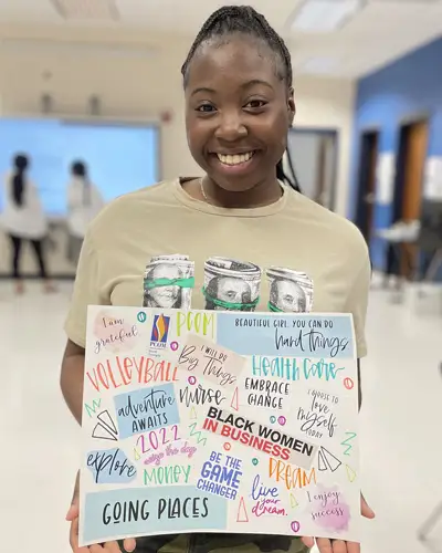 Brooks County High School student holding sign