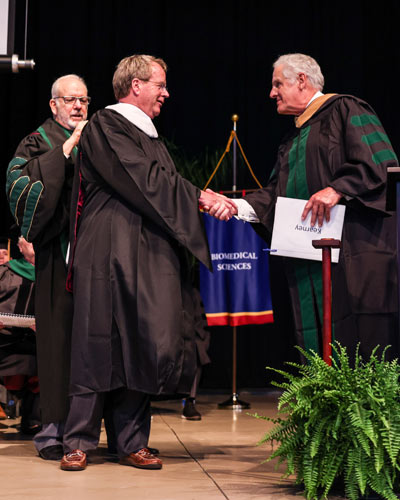 Jim Matney receives honorary degree from board member John P. Kearney 