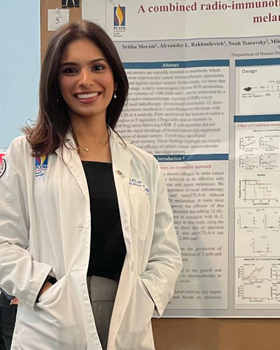 PCOM South Georgia medical student Sritha Moram (DO ’25) stands with her research poster