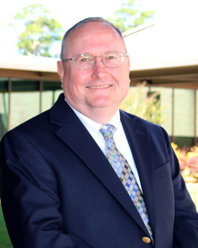 Robert Lloyd, DO ’91 posing outside the PCOM South Georgia campus