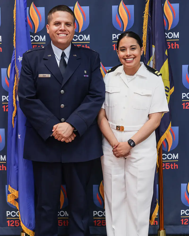 Travis Tuck, DO ’24, and Alexis Rodriguez, DO ’24, in uniform standing together.