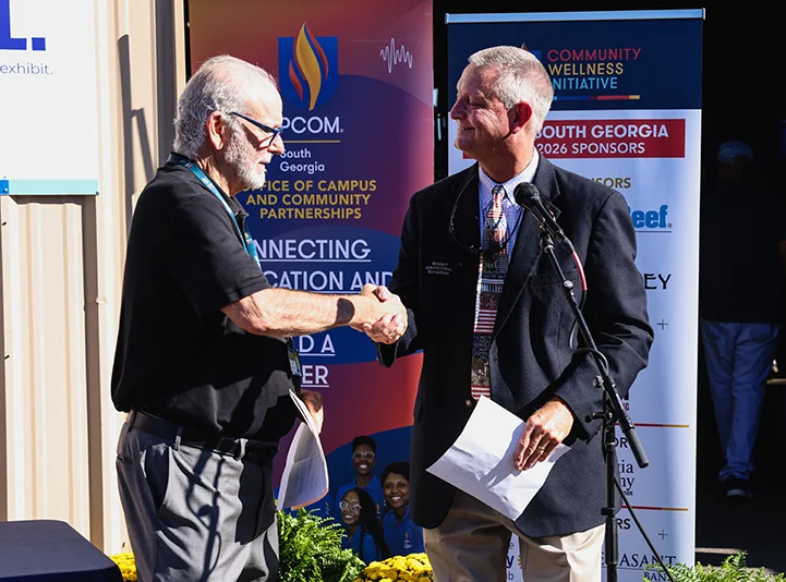 PCOM President and CEO, Dr. Jay S. Feldstein shakes hands with Sunbelt Ag Expo Executive Director, Chip Blalock