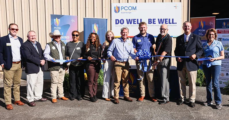 Group of PCOM staff and Georgia agriculutral leaders standing side-by-side holding ceremonial ribbon