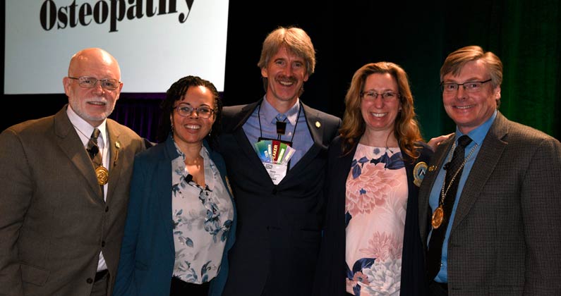 Dr. Fuller poses and smiles with the other speakers at the event