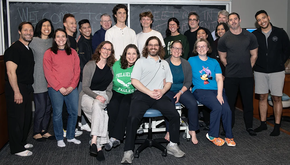 Students, faculty and guests smiling for a group photo in a classroom after the April 2026 PCOM OMM Ligamentous Articular Strain CME Course