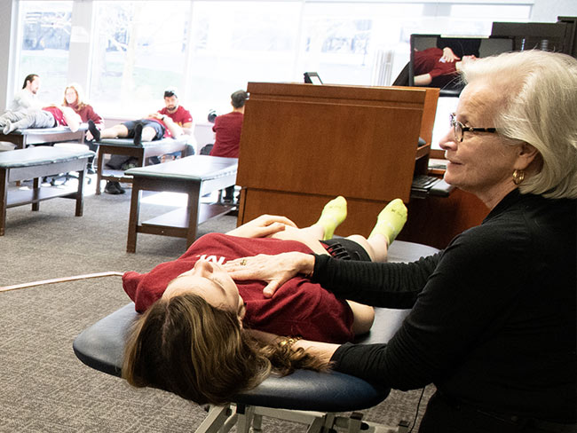 OMM faculty member demonstrating OMM techniques on student