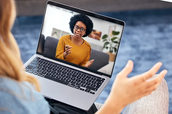 A college student views a virtual workshop about counseling professions on a laptop