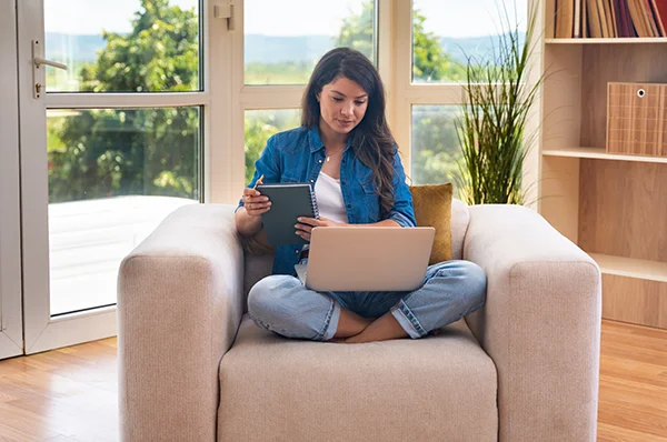 A student uses a laptop to attend PCOM's MS in Mental Health Counseling virtual information session event