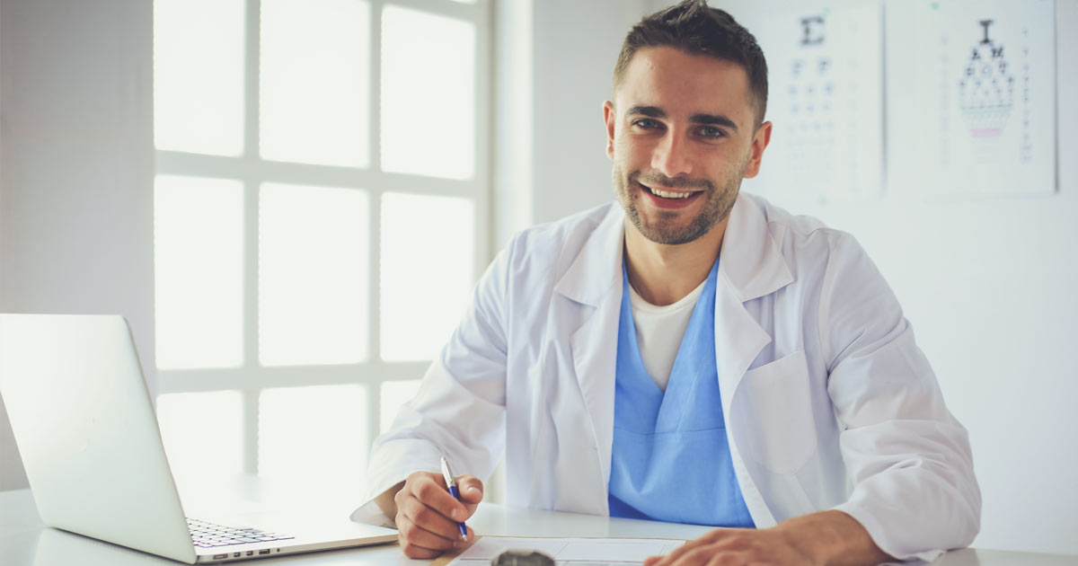 PCOM Doctor of Osteopathic Medicine student takes notes while sitting in exam room