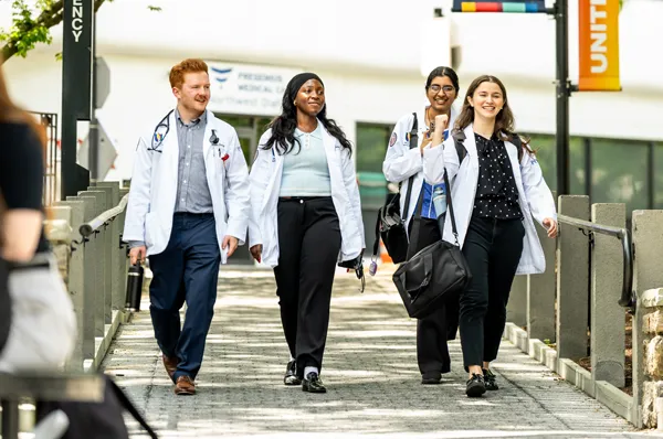 PCOM Doctor of Osteopathic Medicine students walking and talking during a Philadelphia campus tour event