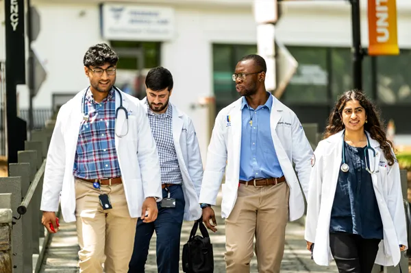 PCOM DO medical students walking and talking during an campus tour event on the Philadelphia campus