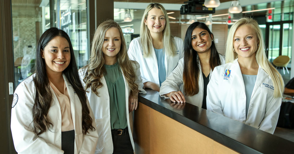 Student female doctors smiling at PCOM South Georgia's campus