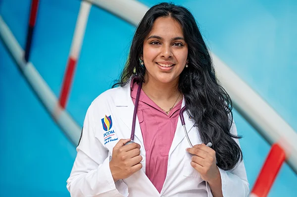 Osteopathic medical student smiling in the main lobby of PCOM Georgia in Suwanee