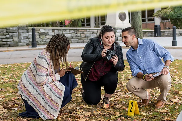 PCOM forensic medicine students work together on a field exercise including a mock crime scene investigation on the Philadelphia campus