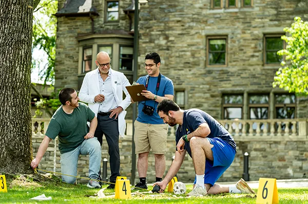 Forensic medicine students and Dr. McDonald explore a mock crime scene investigation on PCOM's Philadelphia campus
