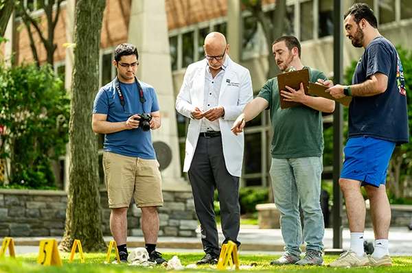 Forensic medicine students explore a hands-on crime scene investigation exercise out with a PCOM faculty member