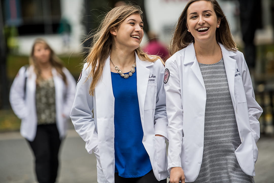 PCOM DO students walk across the PCOM Philadelphia campus together