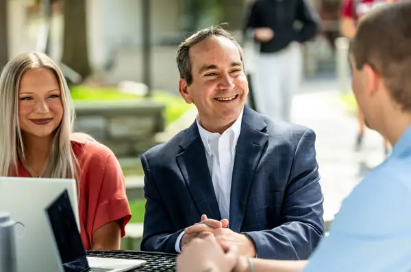 PCOM MAPP program director Dr. Scott Glassman smiles while speaking with students on campus