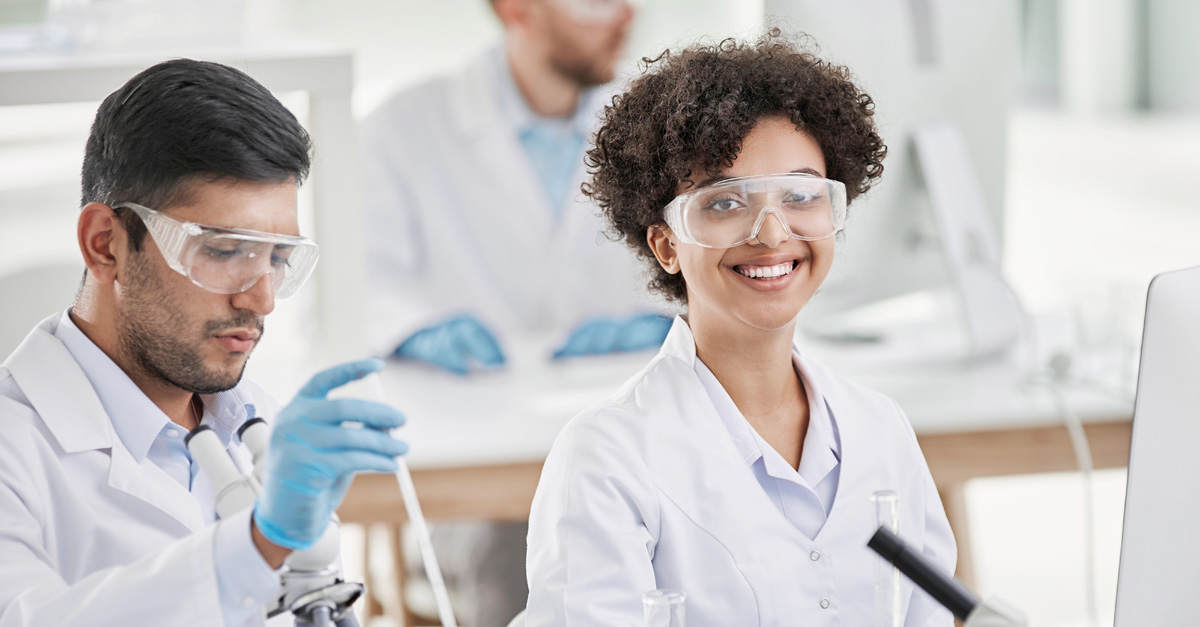 PCOM Georgia medical laboratory science students smiling as they perform a hands-on learning exercise in a lab