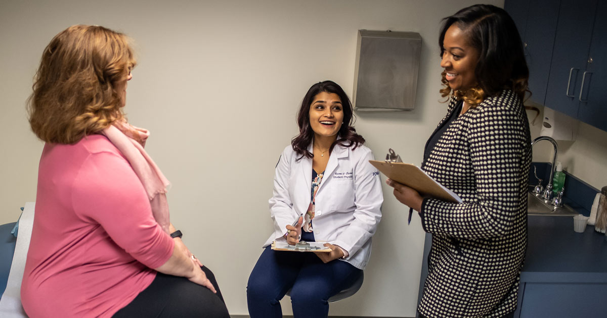 Female psychologist aids physician in delivering a patient consult