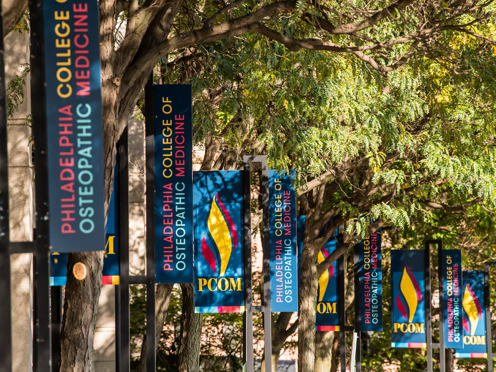 PCOM banners lining campus walkway