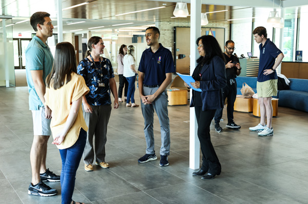 PCOM South Georgia staff and prospective students talking in the lobby during a campus tour event