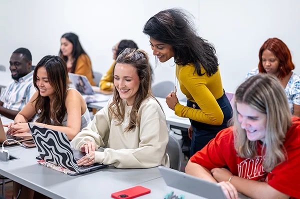 Prospective students smile with a PharmD faculty member during an interactive learning session at a PCOM Georgia admissions event