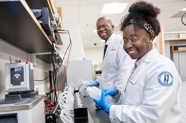 PharmD students and prospective students smile during a hands-on learning activity at a PCOM Georgia admissions event